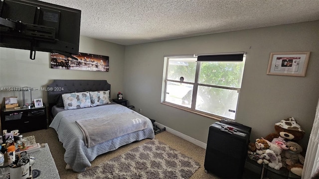 carpeted bedroom featuring a textured ceiling and a wall unit AC