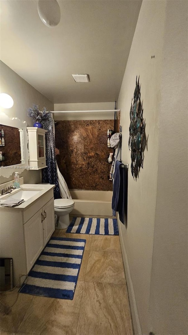 full bathroom featuring tile patterned floors, vanity, shower / bathtub combination with curtain, and toilet