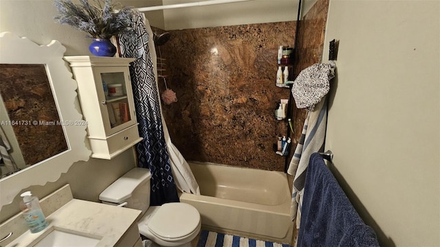 full bathroom with shower / tub combo, vanity, and toilet