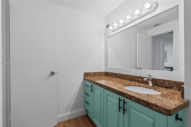 bathroom with hardwood / wood-style flooring and vanity