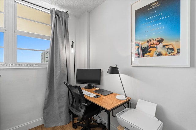 office featuring a textured ceiling and hardwood / wood-style flooring