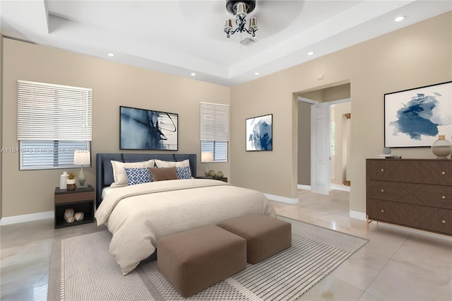 bedroom with a raised ceiling and light tile patterned floors