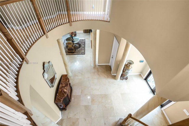 living room featuring tile patterned floors and a towering ceiling