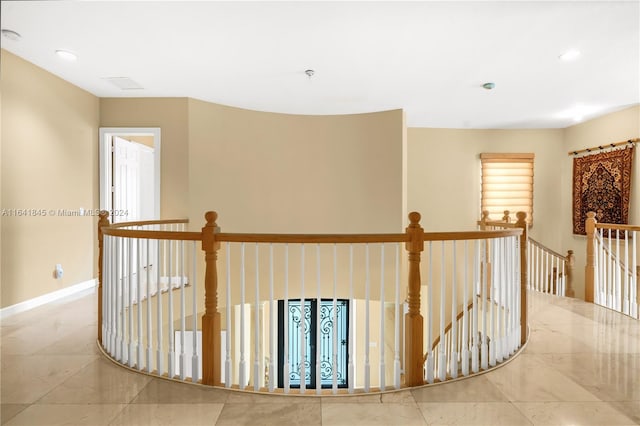 hall with light tile patterned floors