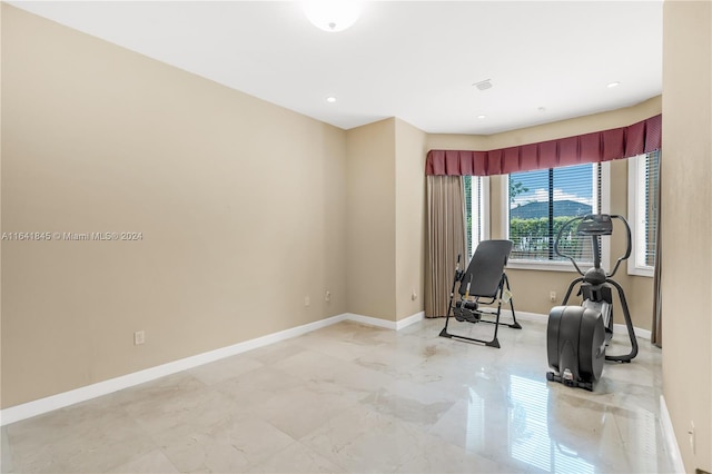 workout room featuring light tile patterned floors