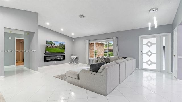 living room featuring vaulted ceiling and light tile patterned floors