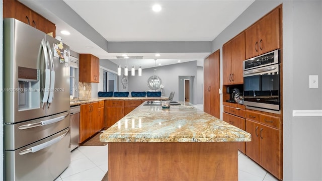 kitchen featuring light tile patterned floors, stainless steel appliances, kitchen peninsula, a kitchen island, and light stone countertops