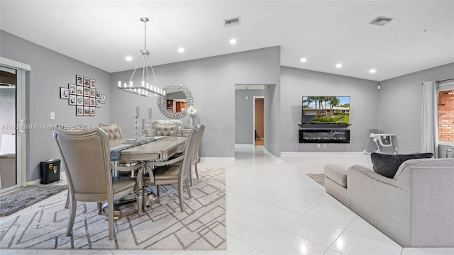 dining space with lofted ceiling and a notable chandelier