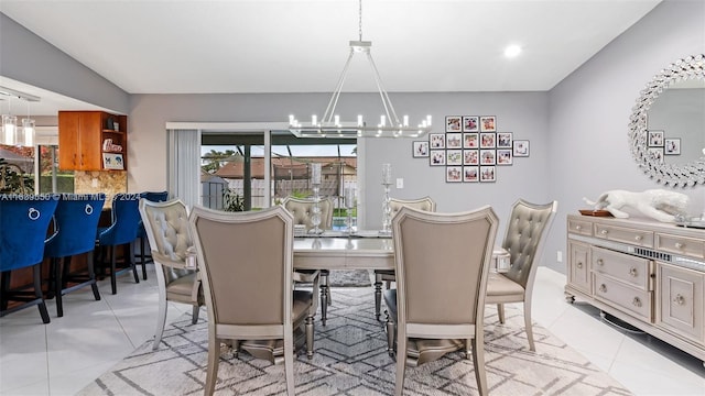 dining area featuring light tile patterned floors and an inviting chandelier