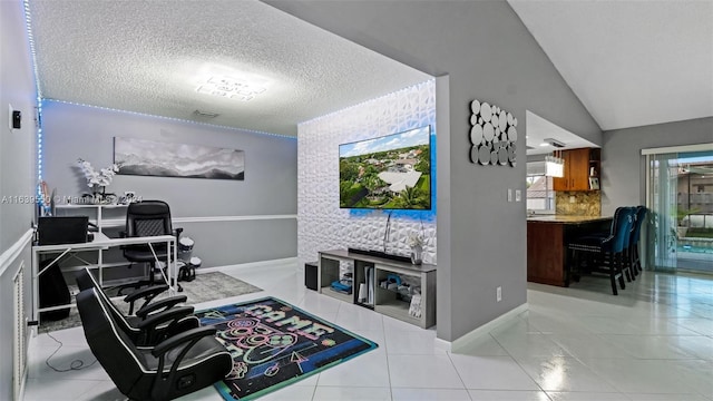 interior space with lofted ceiling, light tile patterned floors, and a textured ceiling