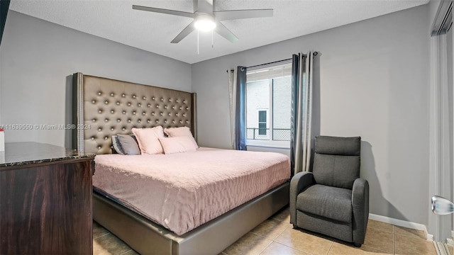 tiled bedroom featuring a textured ceiling and ceiling fan