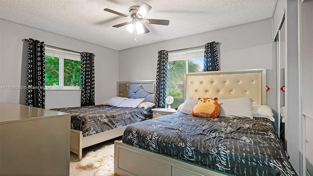 bedroom with a textured ceiling and ceiling fan