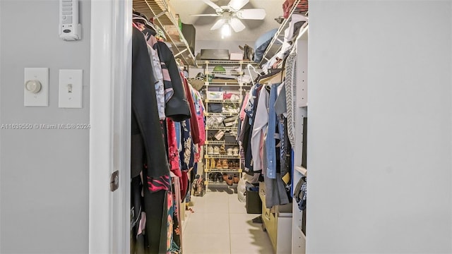 walk in closet featuring light tile patterned floors and ceiling fan