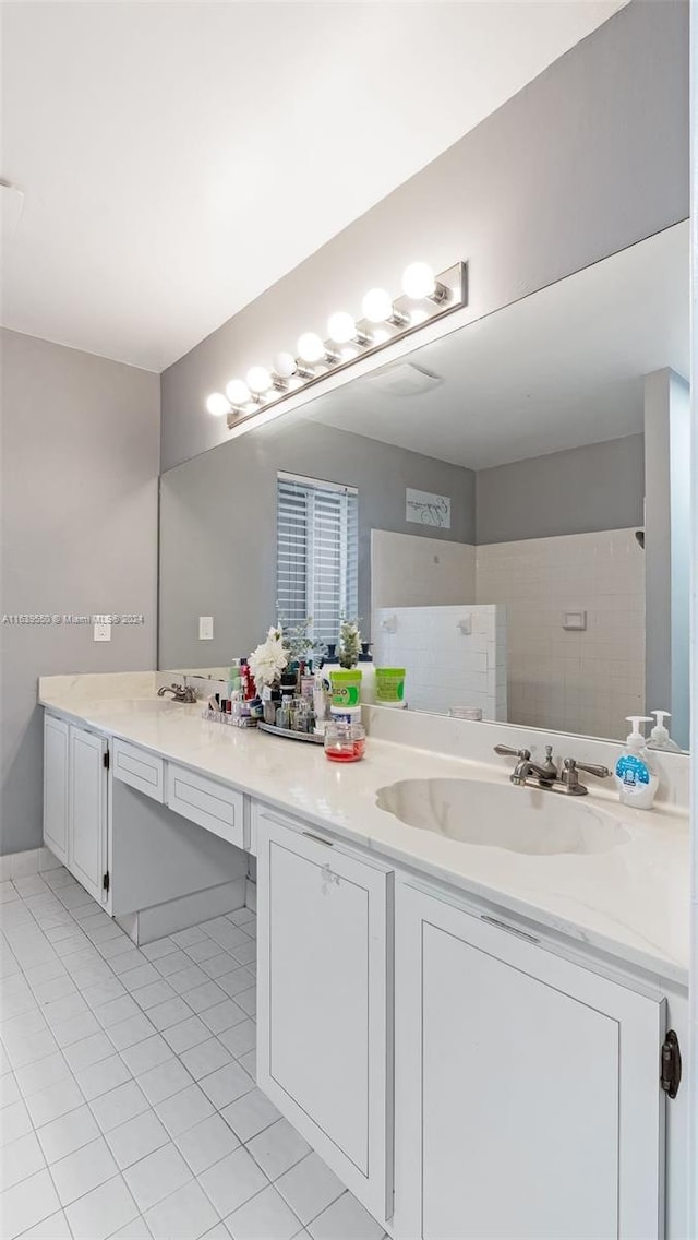 bathroom featuring a shower, tile patterned floors, and vanity