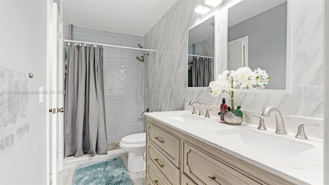 bathroom featuring curtained shower, tile walls, toilet, and vanity