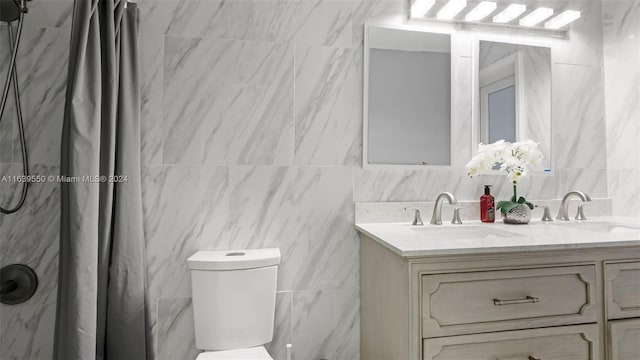 bathroom featuring vanity, toilet, a shower with curtain, and tile walls