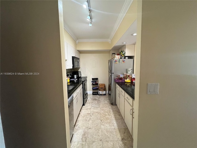 kitchen with crown molding, white cabinets, stainless steel appliances, and track lighting