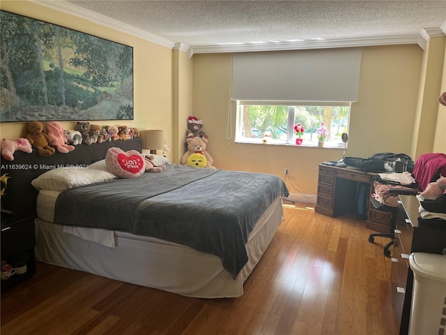 bedroom featuring a textured ceiling, light wood-type flooring, and crown molding