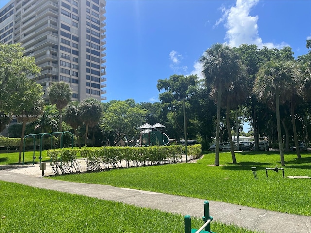 view of property's community with a lawn and a playground