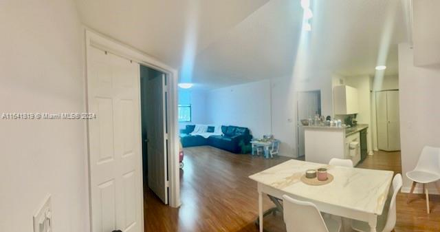 hallway with dark hardwood / wood-style flooring