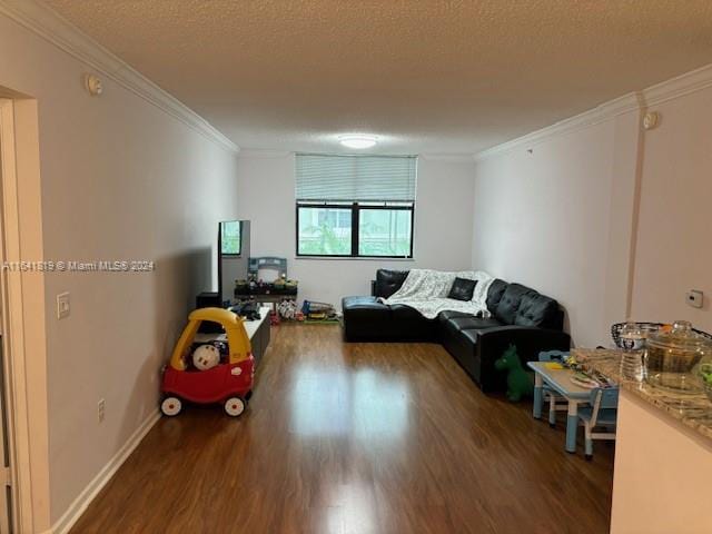 living room with a textured ceiling, crown molding, and wood-type flooring