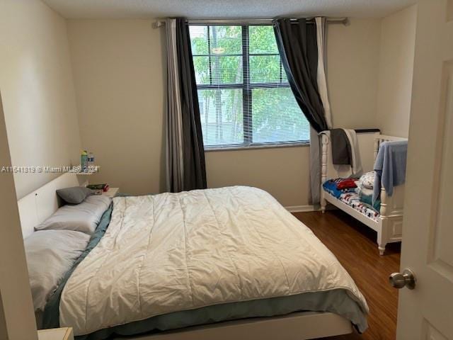 bedroom featuring dark wood-style flooring