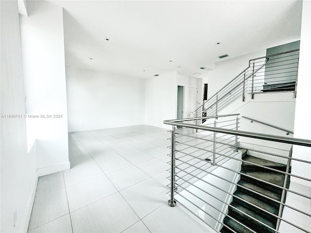 staircase featuring tile patterned flooring