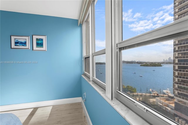 interior space featuring light wood-type flooring and a water view