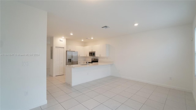 kitchen featuring visible vents, a peninsula, light countertops, appliances with stainless steel finishes, and white cabinetry