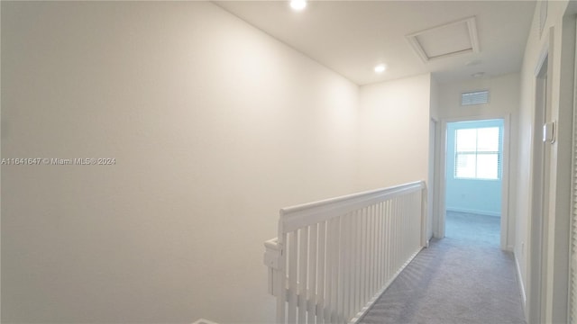 hall featuring visible vents, recessed lighting, attic access, and carpet