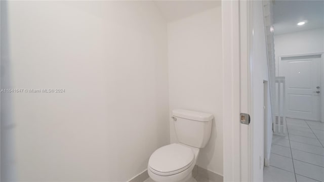 bathroom with tile patterned flooring, toilet, recessed lighting, and baseboards