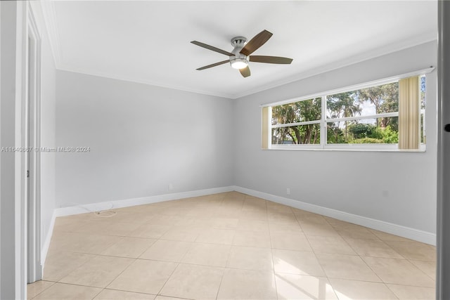 tiled empty room with ornamental molding and ceiling fan