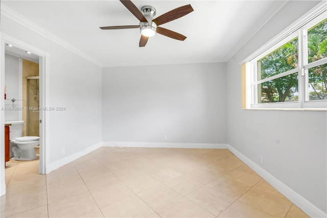 tiled empty room with ceiling fan and crown molding