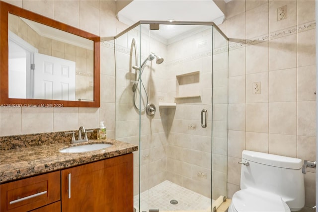 bathroom featuring vanity, tile walls, a shower with shower door, and toilet