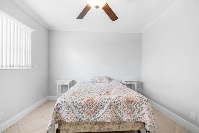 tiled bedroom featuring ornamental molding and ceiling fan