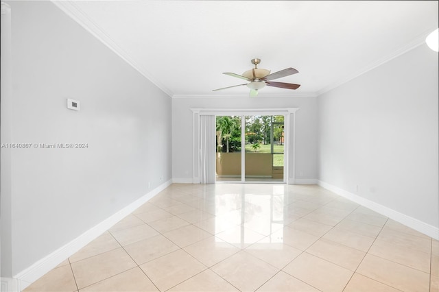 tiled empty room with ornamental molding and ceiling fan