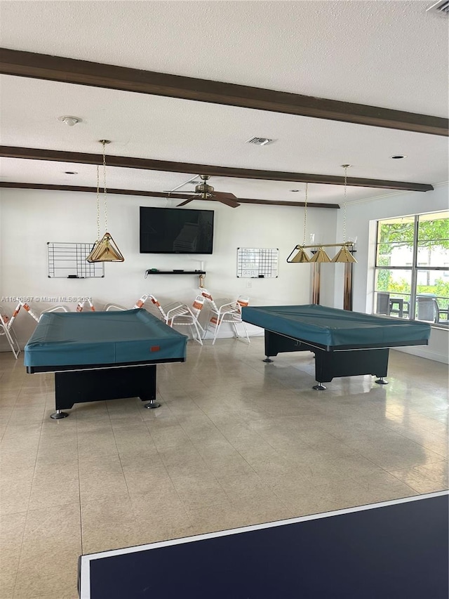 game room featuring pool table, a textured ceiling, and beamed ceiling