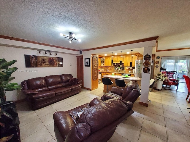 living room with a textured ceiling, ornamental molding, light tile patterned floors, and sink