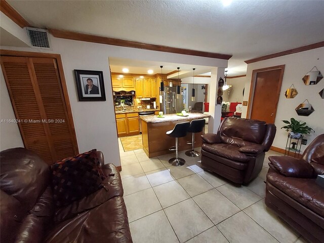 tiled living room with sink and crown molding