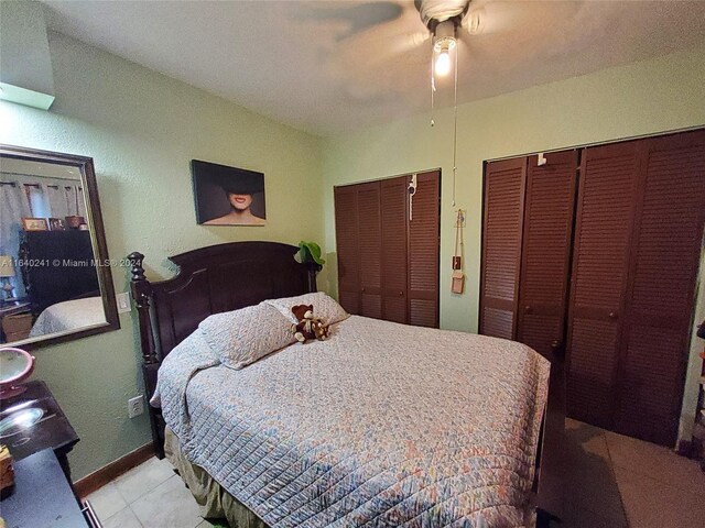 bedroom with light tile patterned flooring and ceiling fan