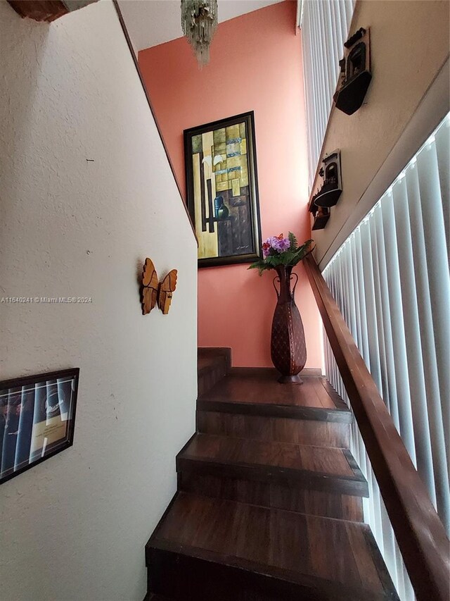 stairway with a chandelier