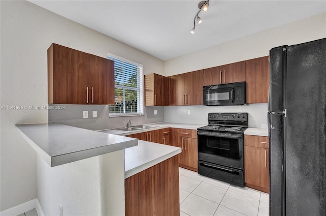 kitchen featuring light tile patterned floors, track lighting, sink, black appliances, and kitchen peninsula