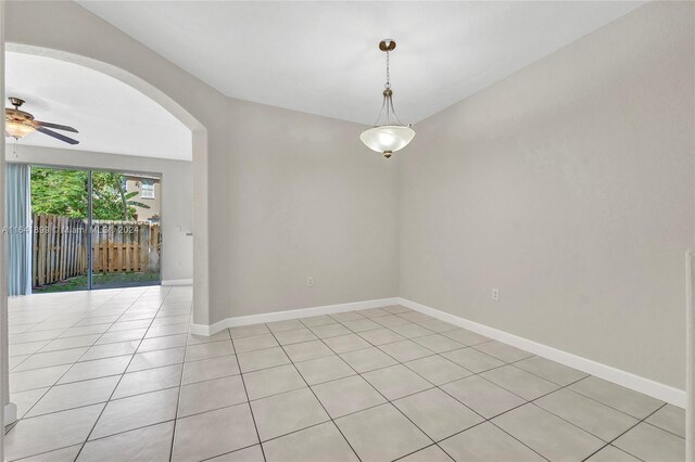 spare room featuring light tile patterned flooring and ceiling fan