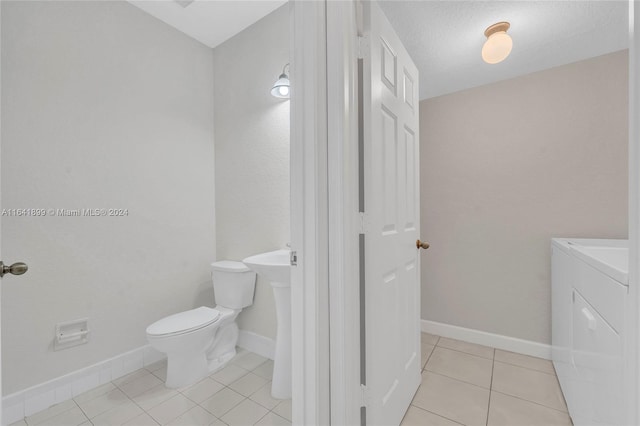 bathroom with vanity, separate washer and dryer, toilet, and tile patterned flooring