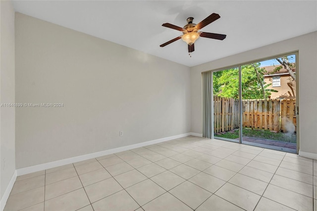 tiled empty room featuring ceiling fan