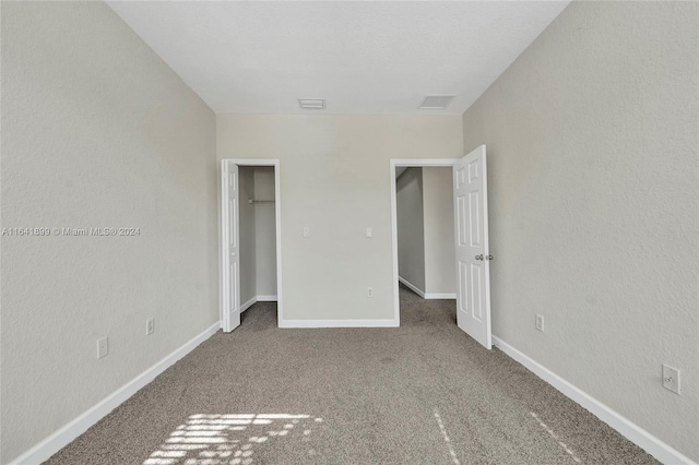 unfurnished bedroom featuring a closet and carpet