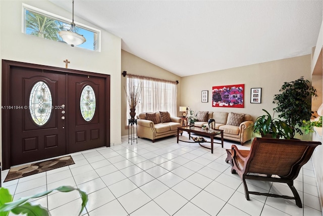 foyer entrance with lofted ceiling and light tile patterned floors