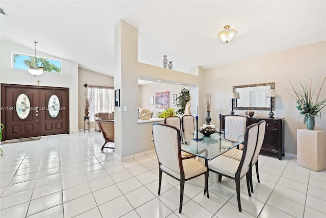 dining space featuring light tile patterned floors, vaulted ceiling, visible vents, and baseboards