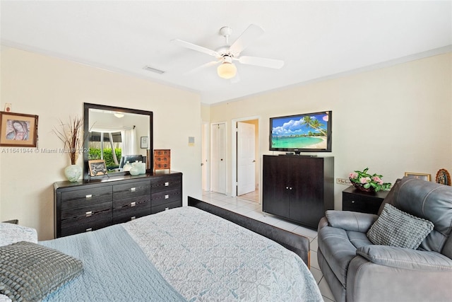 tiled bedroom featuring visible vents and a ceiling fan