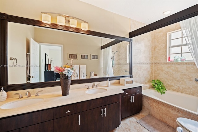 bathroom featuring double vanity, tiled bath, and a sink